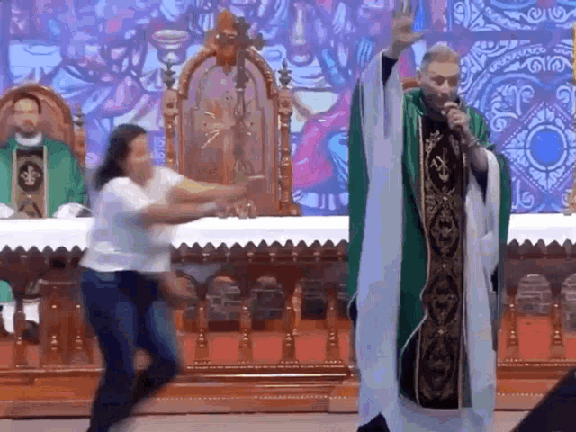 a priest is speaking into a microphone while a woman jumps in the air