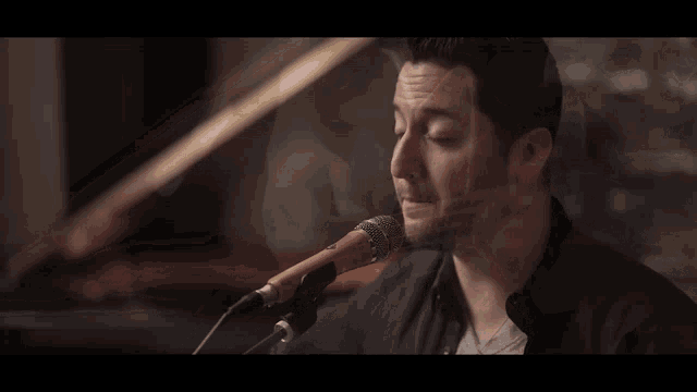a close up of a person playing a guitar with a toggle switch on the neck