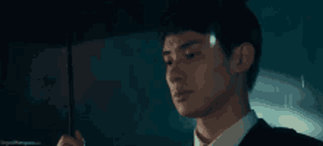 a man is holding an umbrella in the rain .