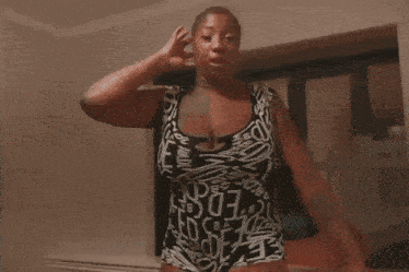 a woman in a black and white swimsuit has the word ed on it