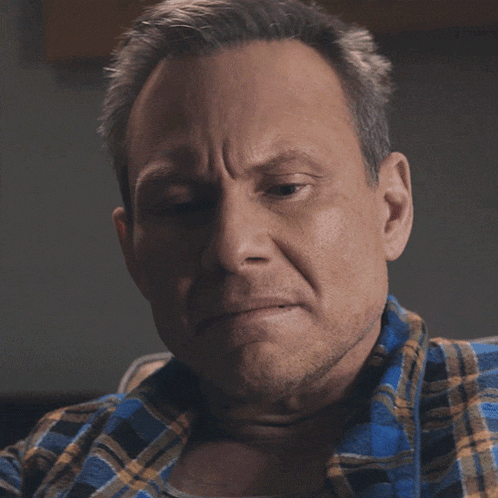 a man in a plaid shirt has the word yes written on his face