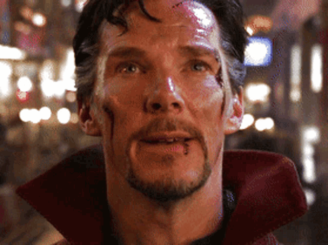 a close up of a man 's face with blood coming out of his mouth