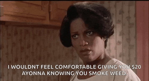 a woman is standing in a kitchen with a serious look on her face and a quote .