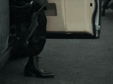 a person is getting out of a car with their boot on