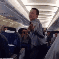 a man in a suit and tie is standing on an airplane
