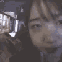 a blurred image of a person 's face with a blurry background