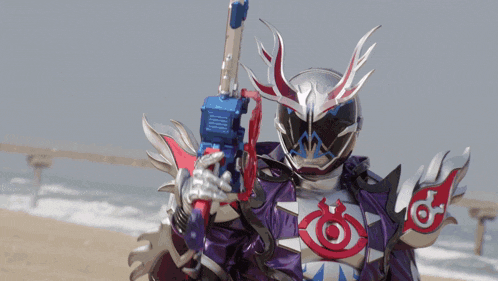 a person in a costume is holding a gun with purple light coming out of it