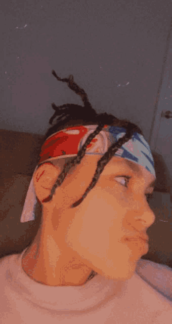 a close up of a person 's face with a headband on