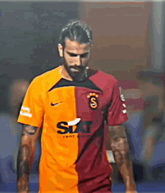 a soccer player wearing a sixt rent a car shirt