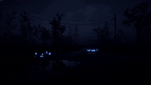 a dark night scene with a few lights shining in the water