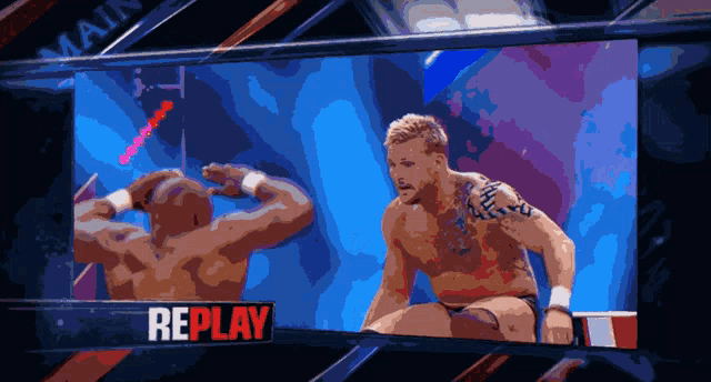 a replay of a wrestling match is shown on the screen