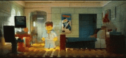 a lego man is standing in a living room with a poster on the wall