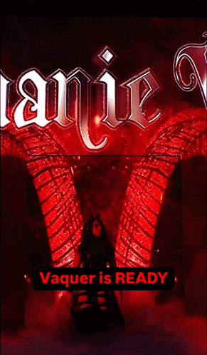 a woman stands in front of a sign that says vampire and vaquer is ready