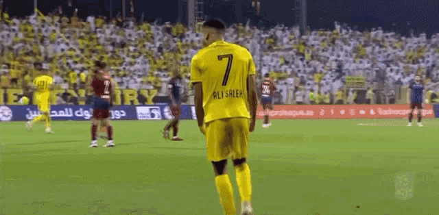 a soccer player wearing a yellow jersey with the number 7