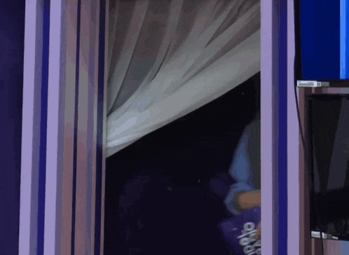 a person is looking through a window with a sign that says okyo