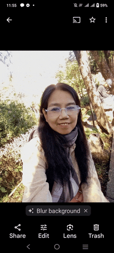 a woman wearing glasses and a scarf is shown in a blurred background