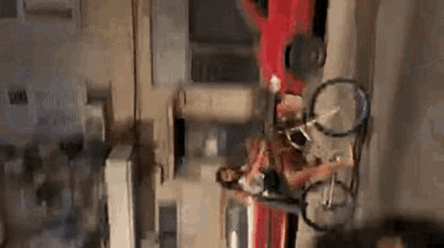 a woman is riding a bike down a street next to a car .