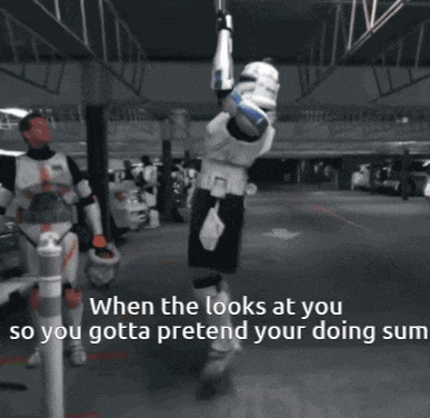a storm trooper is hanging upside down in a parking lot