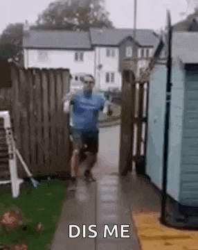 a man is running down a sidewalk next to a fence .
