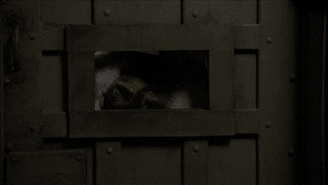 a person is looking through a hole in the wall