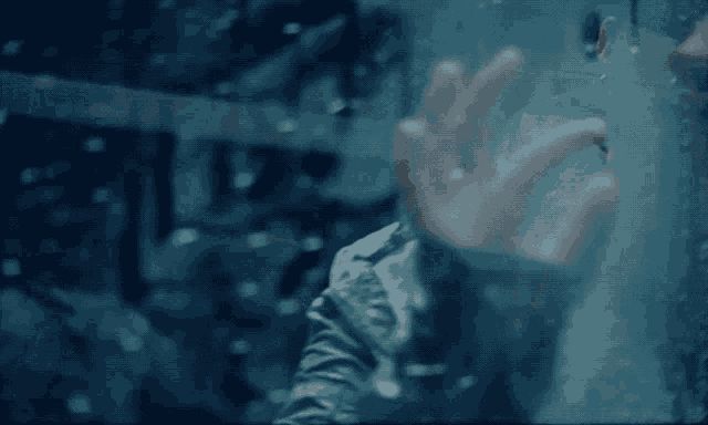 a person 's hand is visible through a window