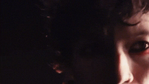a close up of a person 's face with red paint on their face