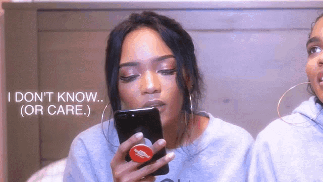 a woman holding a phone with a youtube logo on it