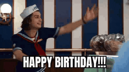 a man in a sailor costume is waving his hand and saying `` happy birthday ! ''