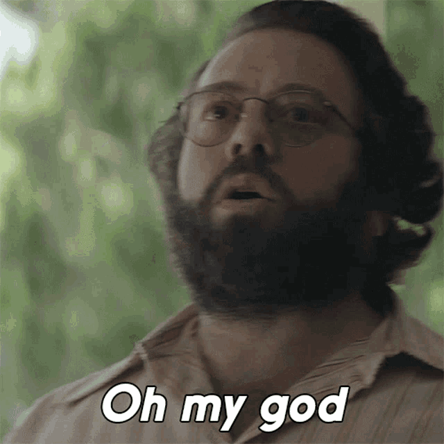 a man with a beard and glasses is saying oh my god