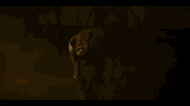 a monster in a dark room with a large head