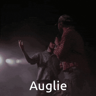 a man in a plaid shirt stands next to another man with the name auglie written on the bottom