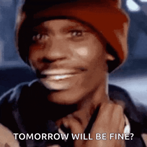 a man wearing a red beanie is smiling and says tomorrow will be fine .