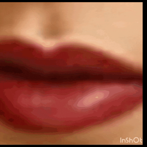 a close up of a woman 's red lips with the words inshot below