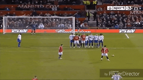 a group of soccer players on a field with an ad for budweiser