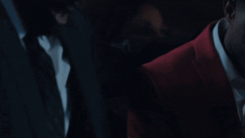 a close up of a man in a suit and tie
