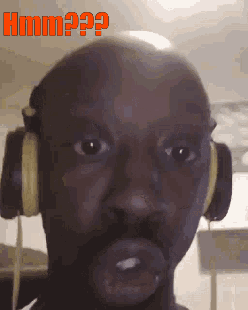 a man wearing headphones has the word hmm on the bottom