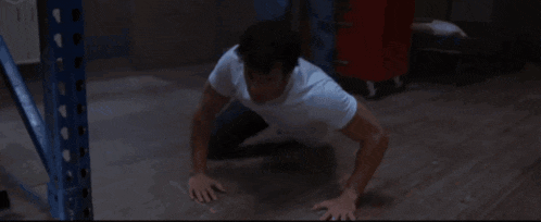 a man in a white shirt is laying down on the floor