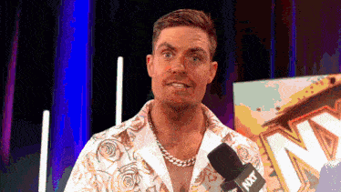 a man talking into a microphone with nxt written on it