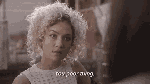 a woman with blonde curly hair says you poor thing