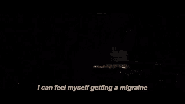 a woman is taking a shower in a dark room and saying i can feel myself getting a migraine .