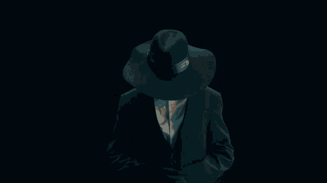 a woman wearing a hat and a suit with gloves