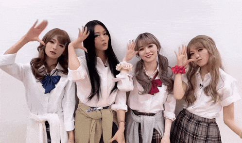 a group of girls in school uniforms pose for a picture