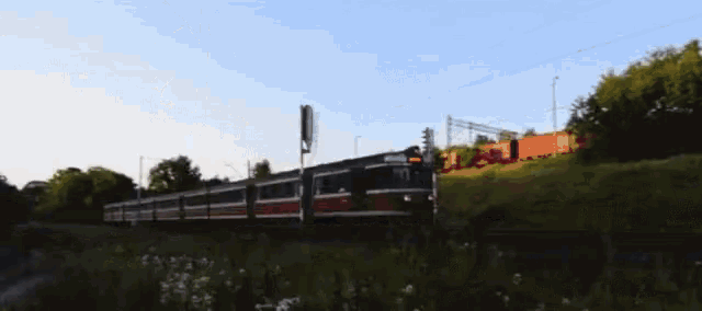 a train is going down the tracks with the number 73 on the front