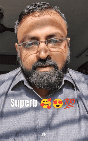 a man with a beard wearing glasses and a shirt that says superb 100