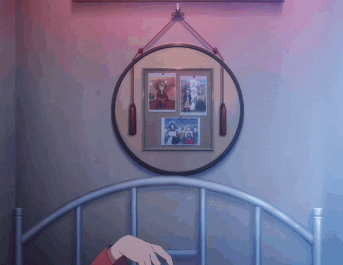 a framed picture hangs above a bed in a bedroom