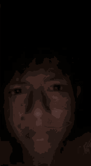a close up of a person 's face in the dark
