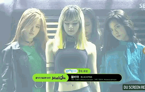 a group of women are standing next to each other with a green sign that says melon