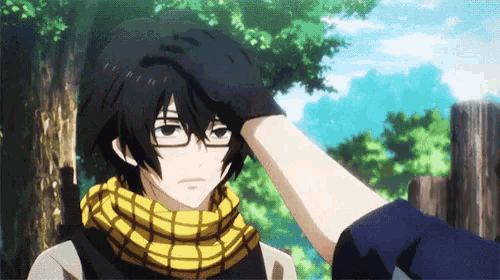 a person touching another person 's head with a black hand