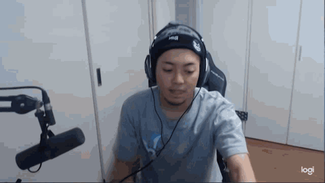 a man is wearing headphones and a headband that says logi