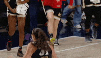 a female basketball player wearing a number 21 jersey